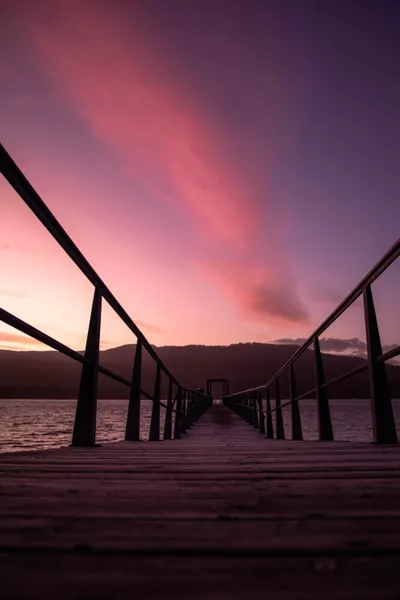 A vibrant sunset painting the sky over the historic Port Arthur site.